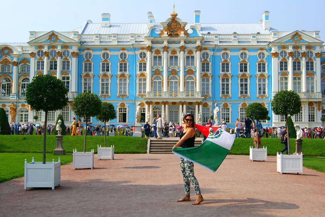 Female UCR student studying in Russia holding Mexican flag 
