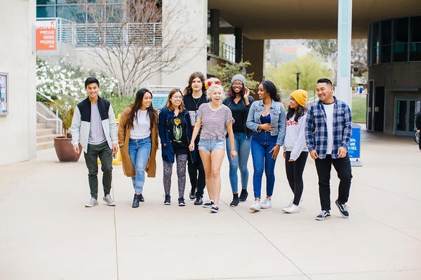 Group of UCR students walking near HUB