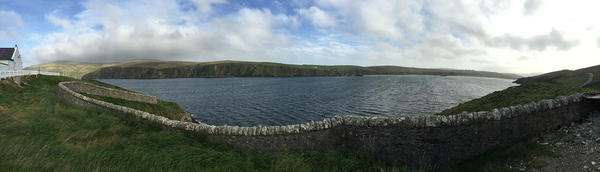 Photo of grassy and ocean landscape in the Shetland Islands, UK