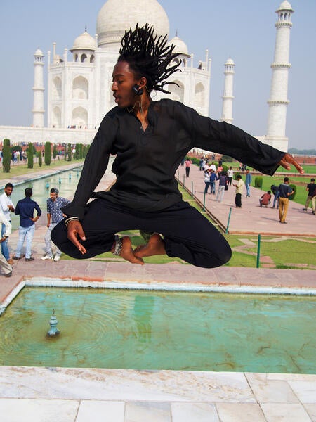 Male UCR student jumping in front of the Taj Mahal