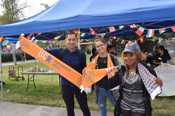 Group of UCR students posing with International Affairs scarves