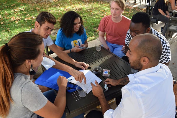 Group of international students playing cards