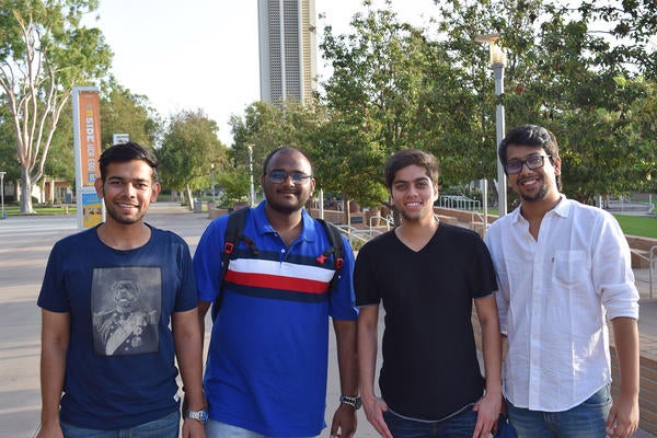 Four male students posing during ISO coffee break