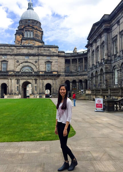 UCR student standing in front of University of Edinburgh