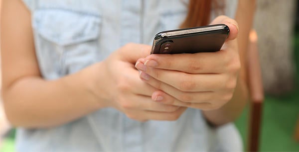 closeup of woman's arms and hands holding cellphone (c) Yura Fresh unsplash