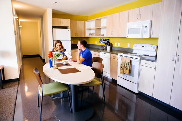 UCR students sitting at table in residence hall kitchenette