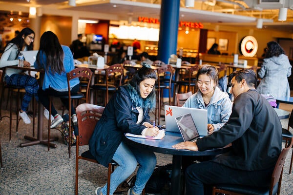 UCR students studying in HUB dining area