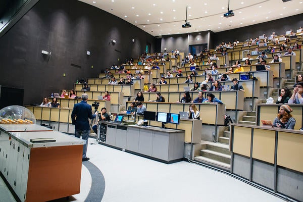 UCR faculty lecturing to class in Physics auditorium
