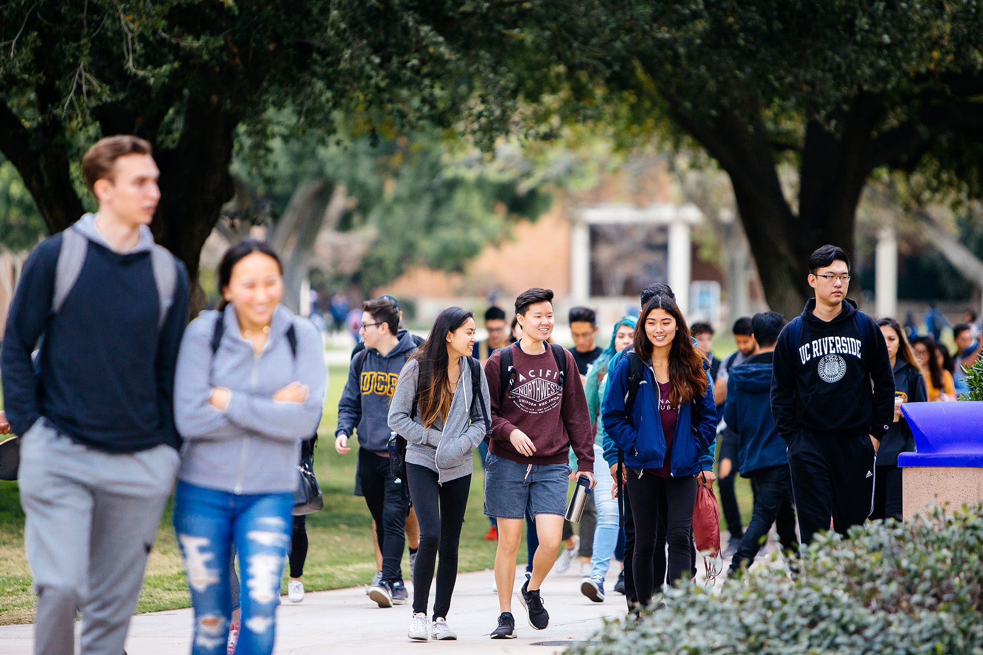 Group of UCR students walking near HUB