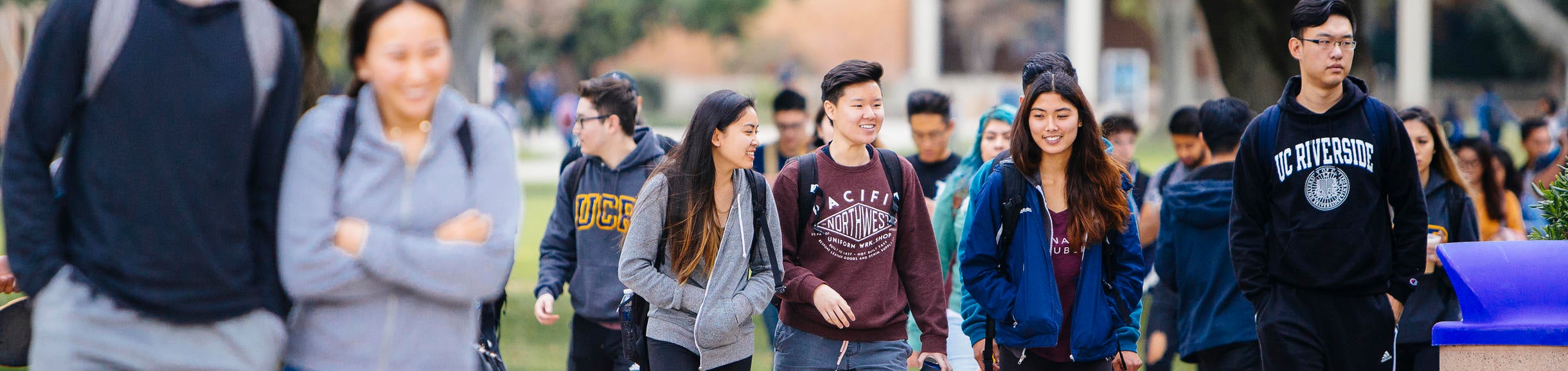 Group of UCR students walking near HUB